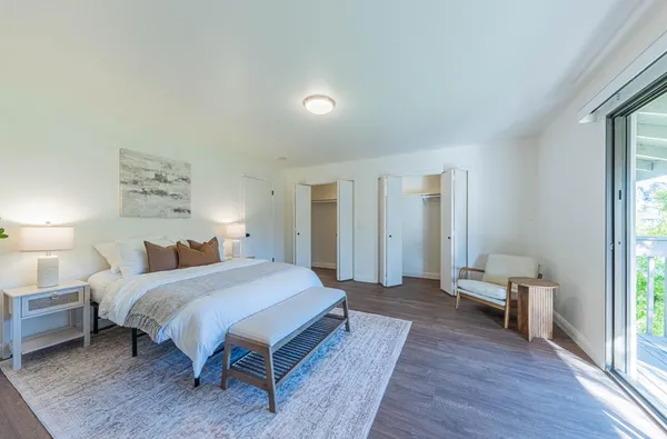 a bedroom with a large bed and a large window