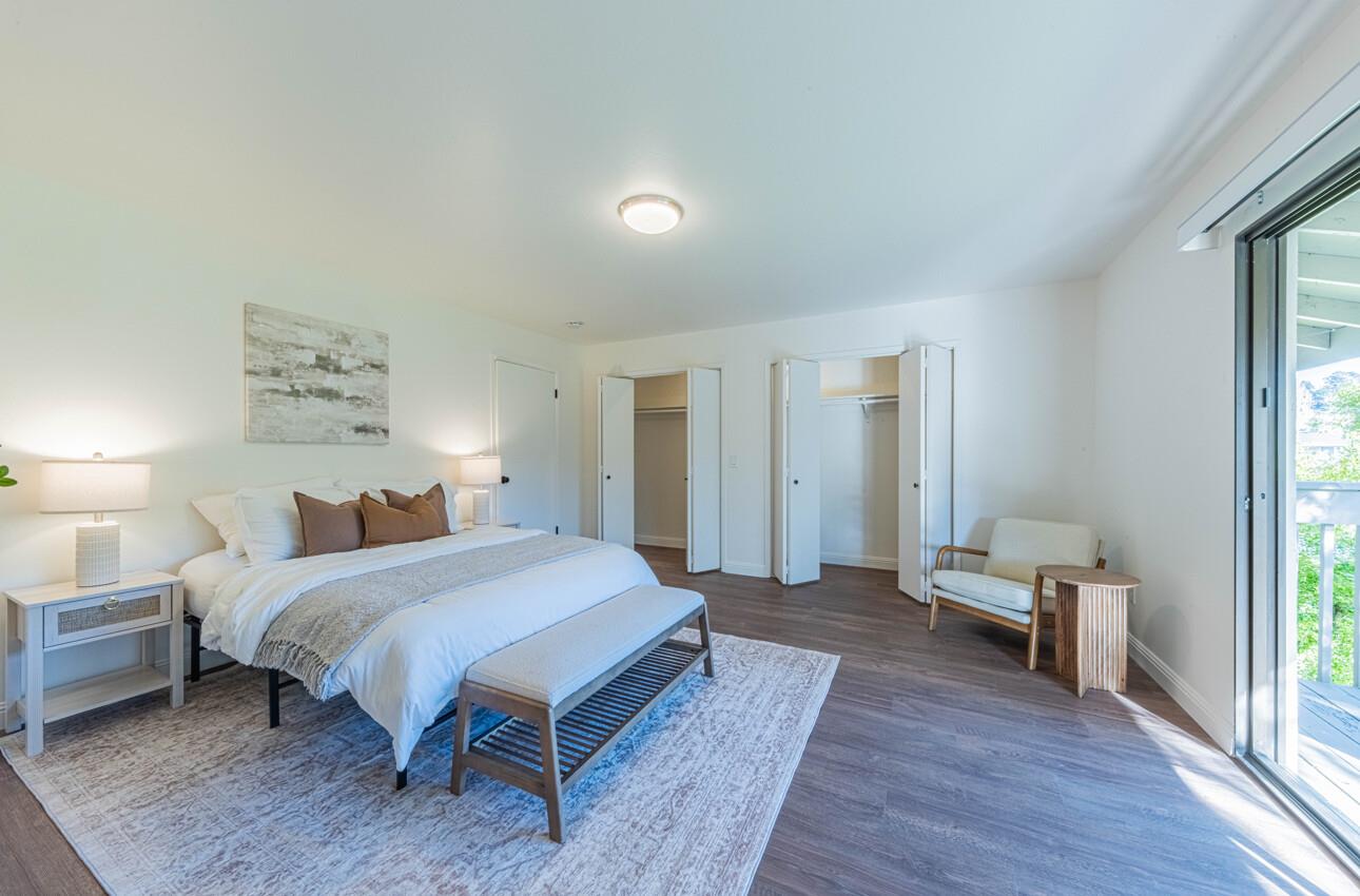 3850 Rio Road, Unit 24 Carmel, CA 93923 - Photo 25 of 39 a spacious bedroom with a bed and a table