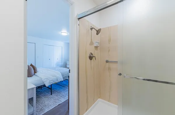 a view of bedroom with a bed and wooden floor