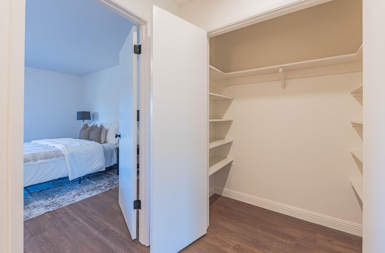 3850 Rio Road, Unit 24 Carmel, CA 93923 - Photo 30 of 39 a view of bedroom with a bed and wooden floor
