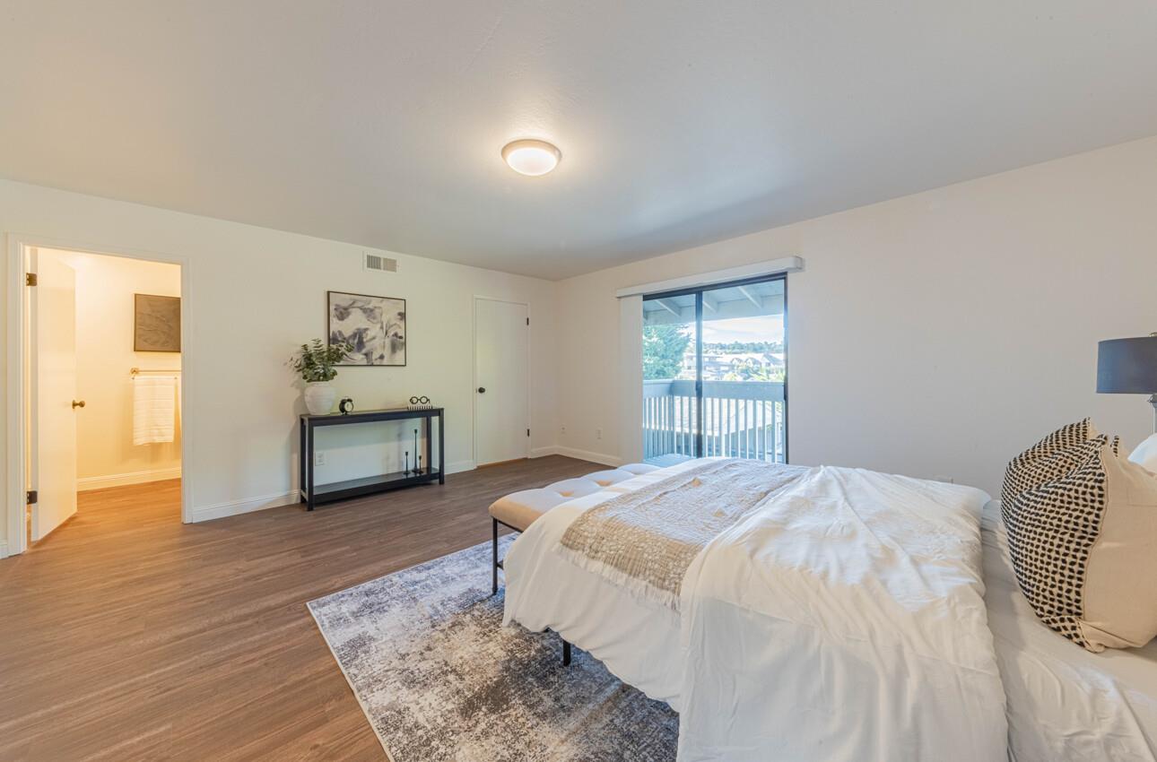 3850 Rio Road, Unit 24 Carmel, CA 93923 - Photo 31 of 39 a spacious bedroom with a bed and a window