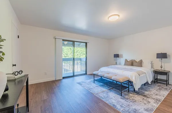 a bedroom with a bed and a painting on the wall