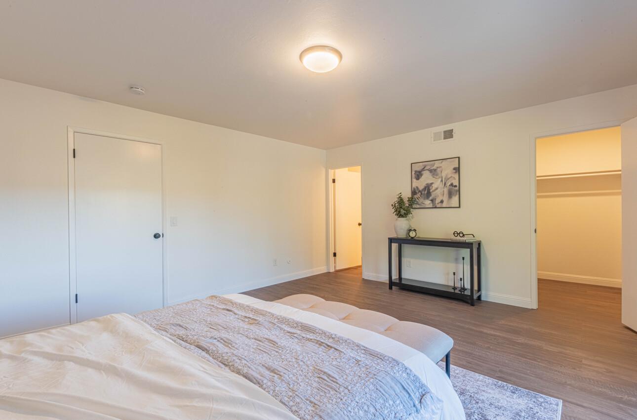 3850 Rio Road, Unit 24 Carmel, CA 93923 - Photo 33 of 39 a bedroom with a bed and a painting on the wall