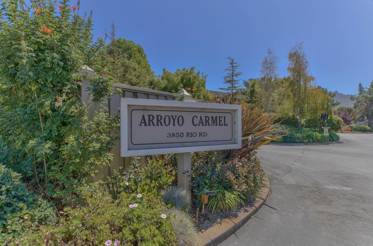 3850 Rio Road, Unit 24 Carmel, CA 93923 - Photo 35 of 39 a sign broad in front of the red brick house