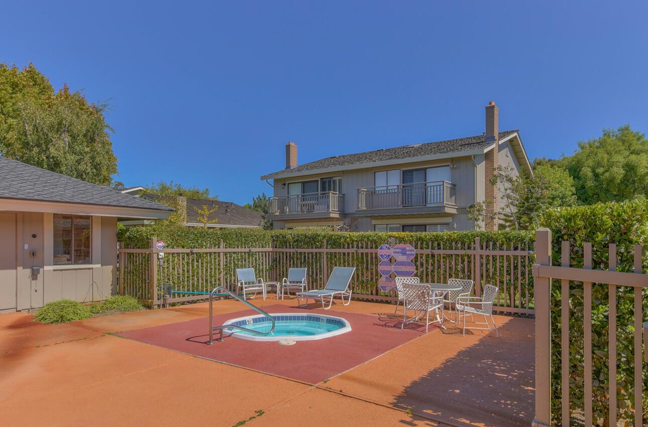 3850 Rio Road, Unit 24 Carmel, CA 93923 - Photo 37 of 39 a backyard of a house with fountain table and chairs