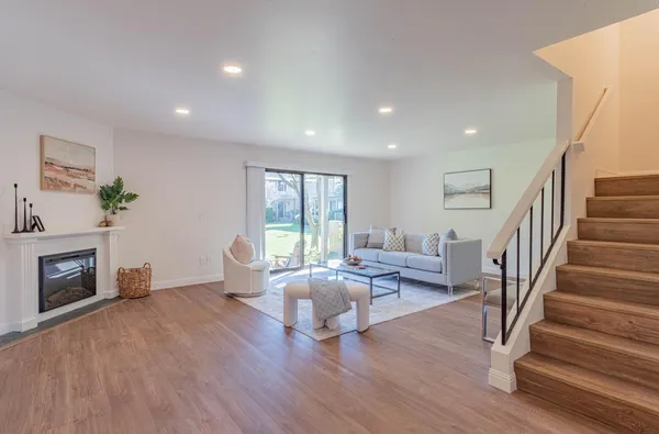 a living room with furniture and a fireplace