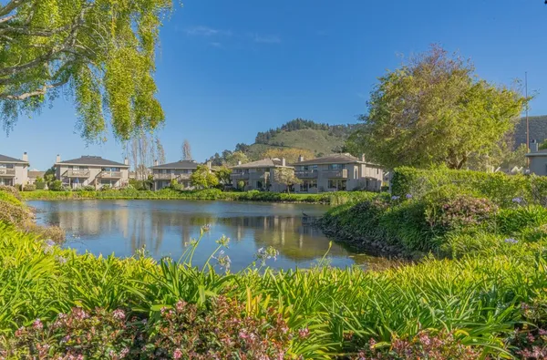 a view of a lake with a house in the background