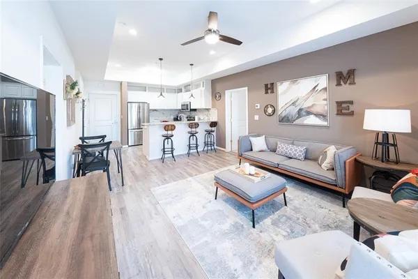 a living room with furniture and a wooden floor