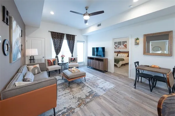 a living room with furniture or couch and a wooden floor