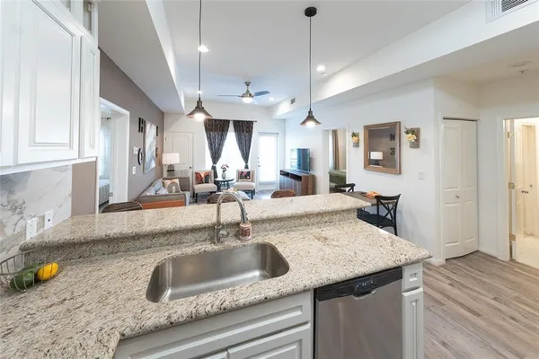 a kitchen with a sink a counter space and cabinets