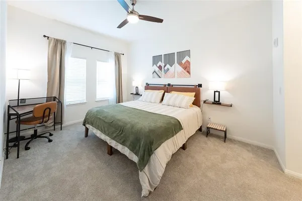 a bedroom with a bed and window