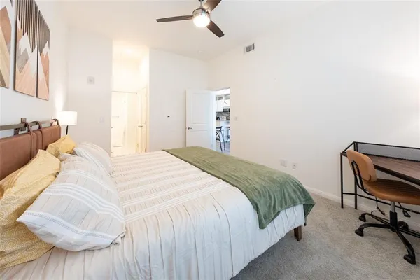 a bedroom with a bed and a chair