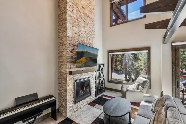 a living room with furniture a rug and a fireplace