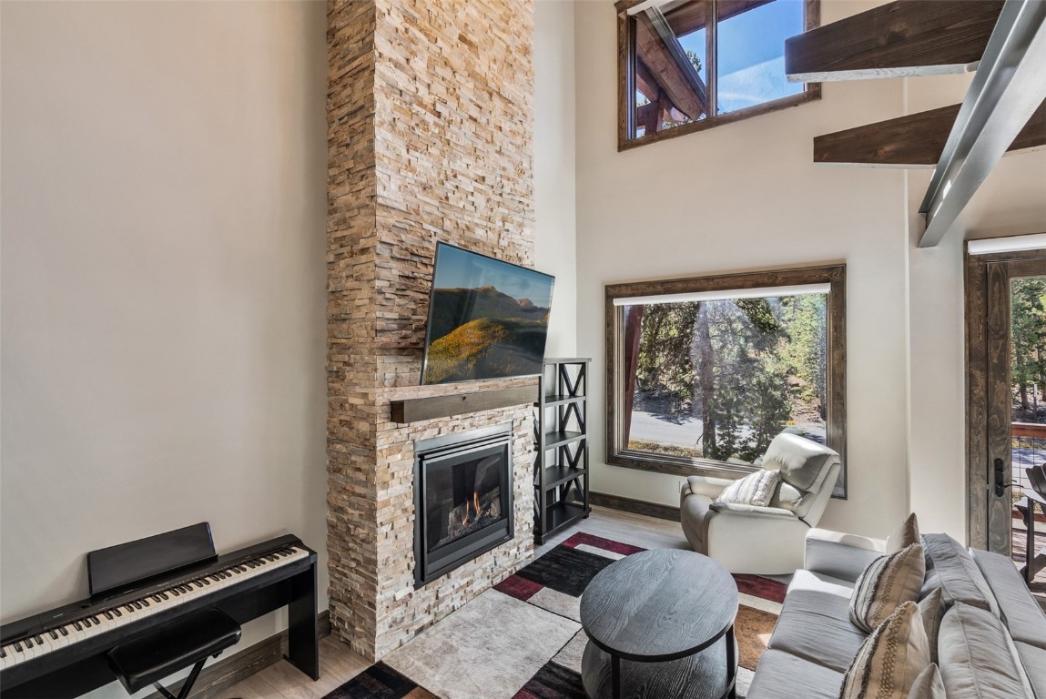 102 Lake Ridge Circle, Unit 1892 Keystone, CO 80435 - Photo 13 of 32 a living room with furniture a rug and a fireplace
