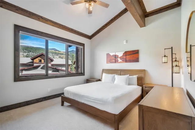 a bedroom with a bed and a painting on the wall