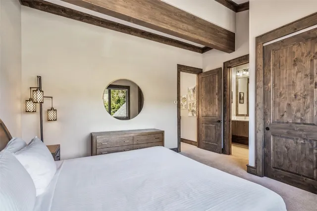 a bedroom with a bed and a chandelier