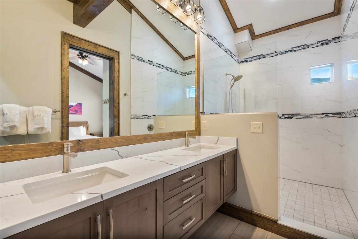 102 Lake Ridge Circle, Unit 1892 Keystone, CO 80435 - Photo 19 of 32 a bathroom with a granite countertop sink and a mirror