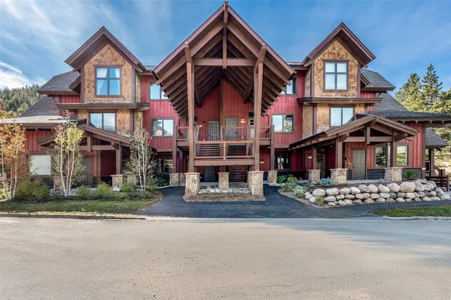 a front view of a residential apartment building with a yard