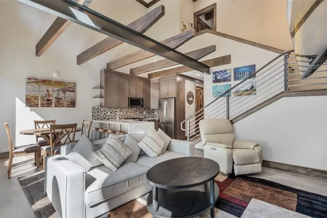 a living room with furniture and a chandelier