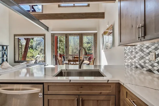a kitchen with a sink and large window