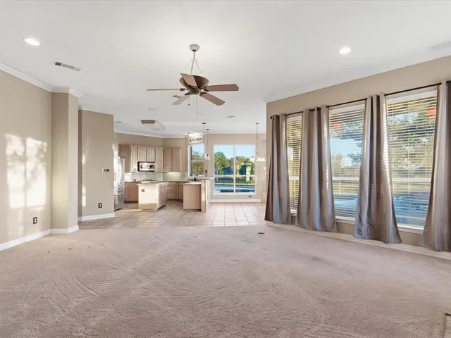 a view of a livingroom with furniture and a large window