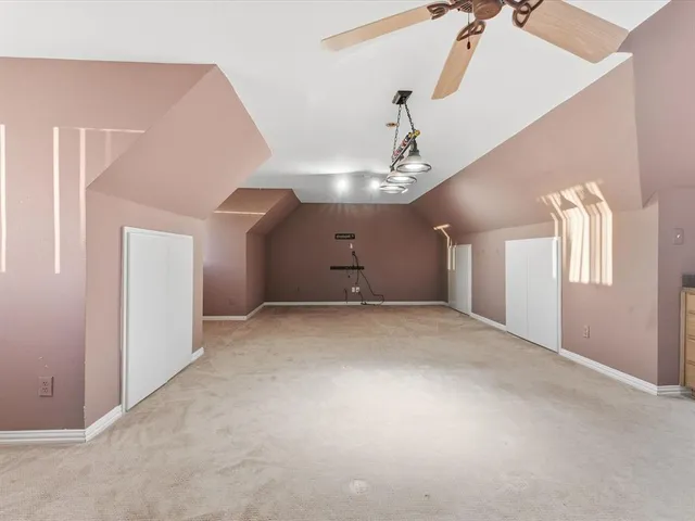 a view of a room with windows and ceiling fan