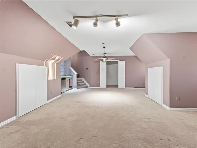 a view of a big room with closet and windows