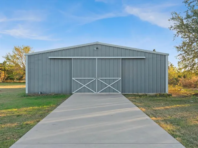 a view of house with backyard and garden