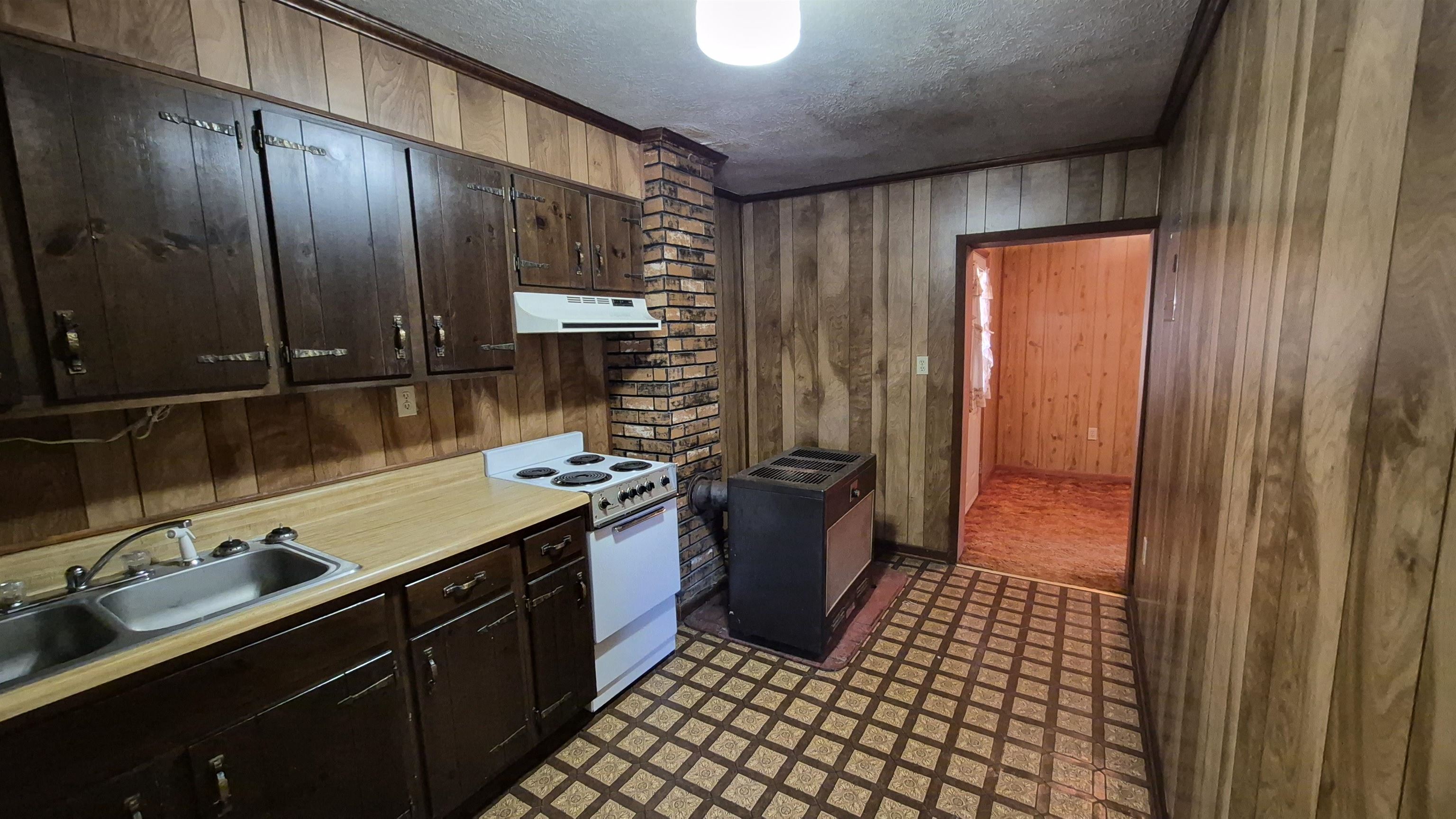211 Watertank Road Millboro, VA 24460 - Photo 9 of 19 a kitchen with a sink cabinets and appliances