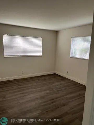 a view of a room with wooden floor
