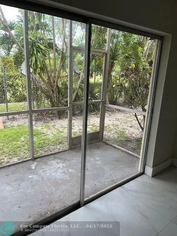 a view of a room with wooden floor and a porch