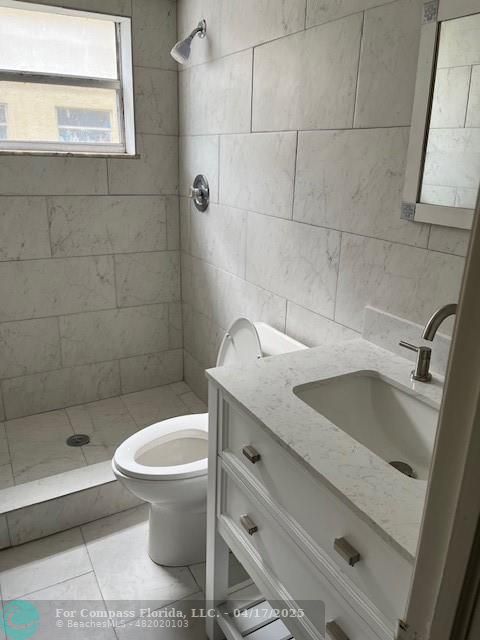 1401 Northwest 45th Street, Unit 4 Deerfield Beach, FL 33064 - Photo 7 of 24 a bathroom with a sink toilet and shower