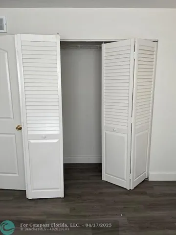 an empty room with wooden floor