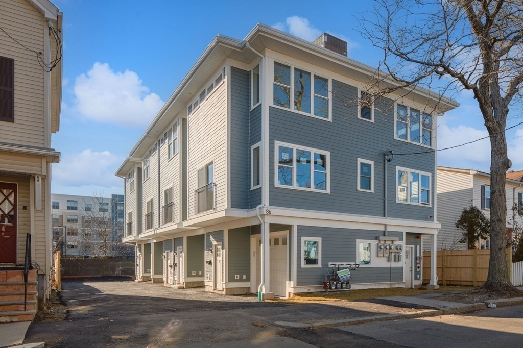 86 Blossom Street, Unit 1 Chelsea, MA 02150 - Photo 1 of 36 a front view of a building with a garden