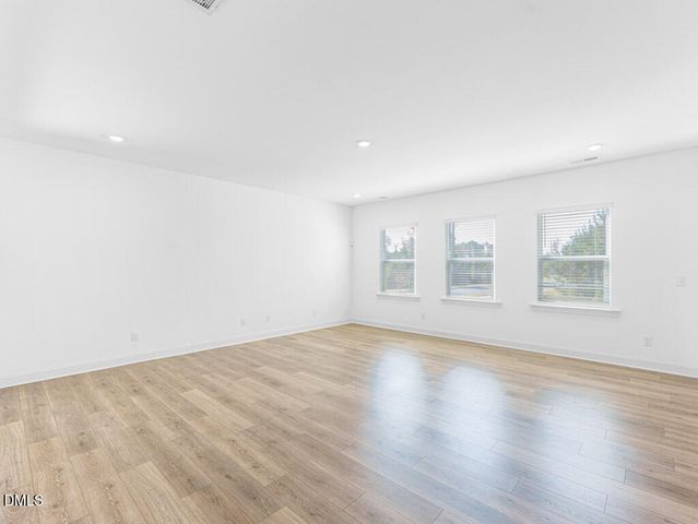 a view of a room with wooden floor and staircase