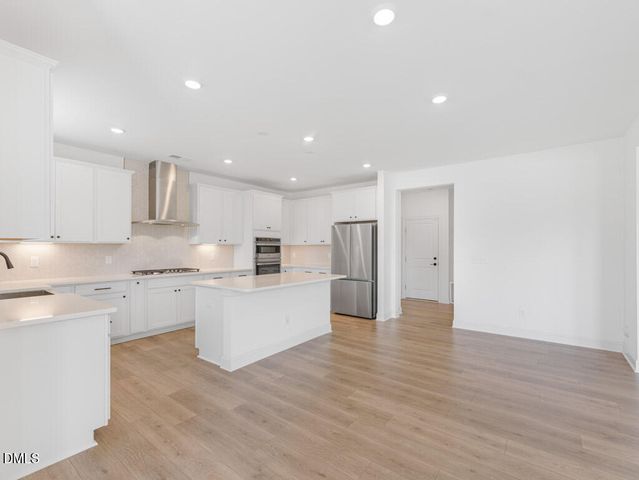 a kitchen with a stove and cabinets