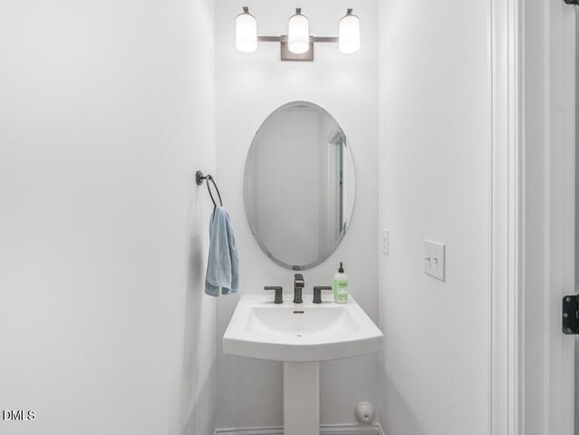 a kitchen with a refrigerator and white cabinets
