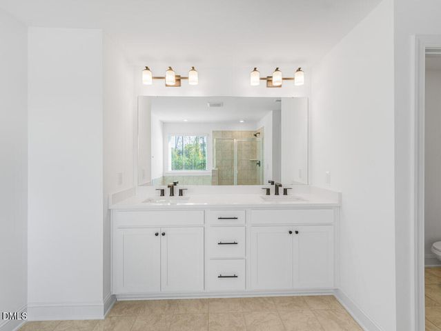 a bathroom with a sink vanity and mirror