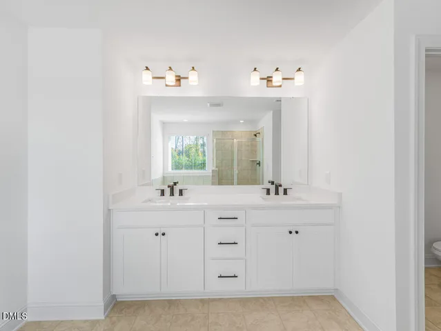 a bathroom with a sink vanity and mirror