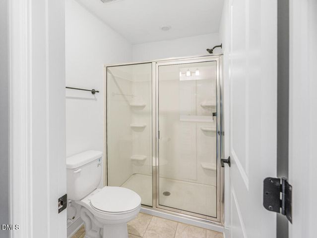 a bathroom with a shower and a toilet