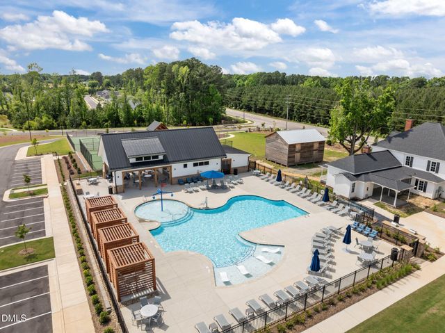 a view of a tennis ground with a large trees