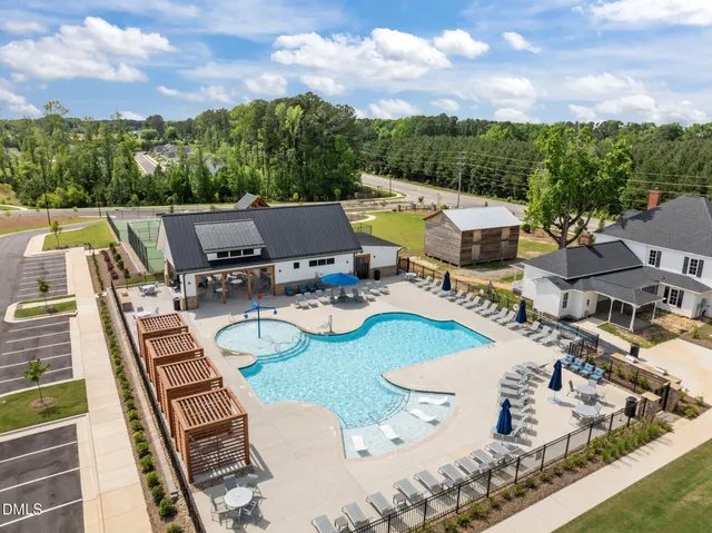 a view of a tennis ground with a large trees