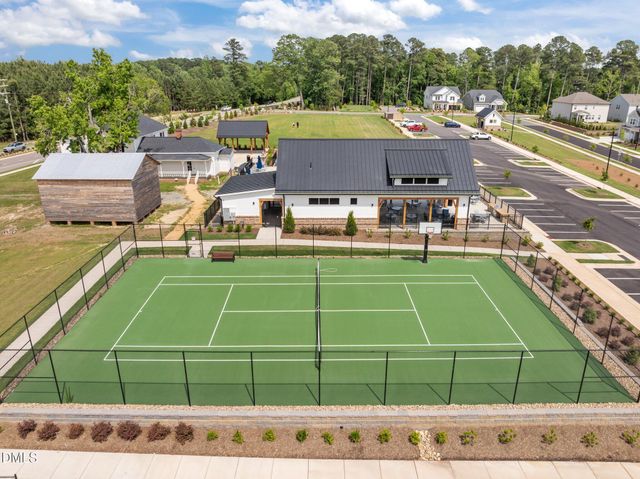 a view of a tennis ground with chairs in the patio