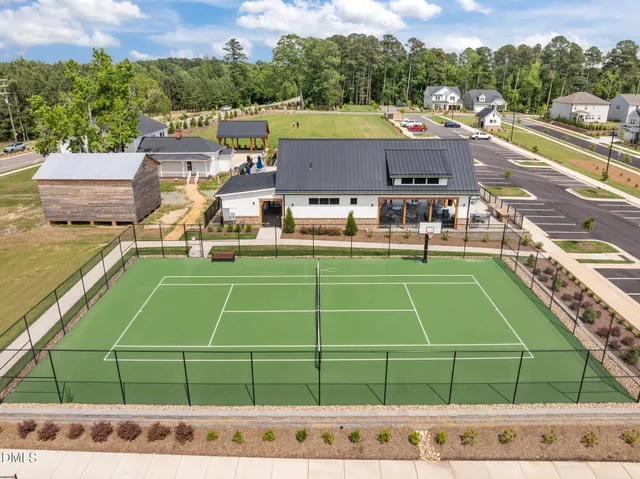 a view of a tennis ground with chairs in the patio