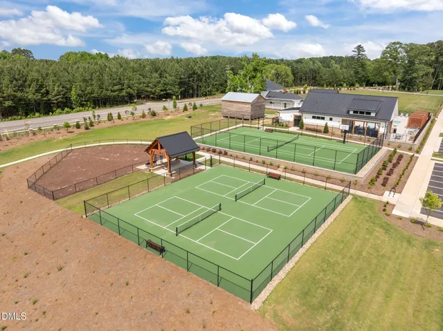 an aerial view of a house with a swimming pool patio and outdoor seating