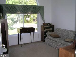 5 Watertown Road Ocean Pines, MD 21811 - Photo 9 of 10 a living room with furniture and a floor to ceiling window