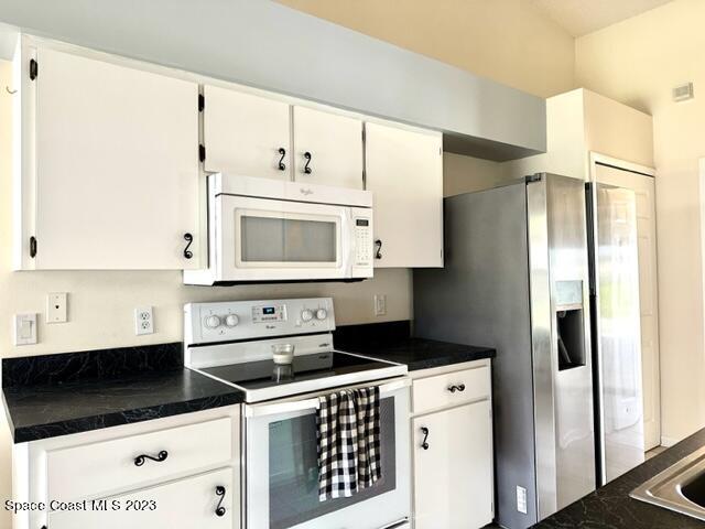 1040 Wing Road Southwest Palm Bay, FL 32908 - Photo 11 of 52 a kitchen with a refrigerator and a sink