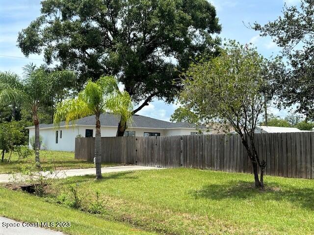 1040 Wing Road Southwest Palm Bay, FL 32908 - Photo 3 of 52 a backyard of a house with lots of green space