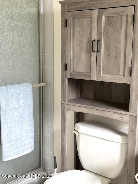 1040 Wing Road Southwest Palm Bay, FL 32908 - Photo 32 of 52 a bathroom with a toilet a sink and a mirror
