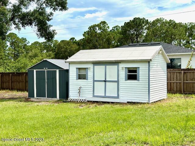 1040 Wing Road Southwest Palm Bay, FL 32908 - Photo 39 of 52 a view of a white house with a yard